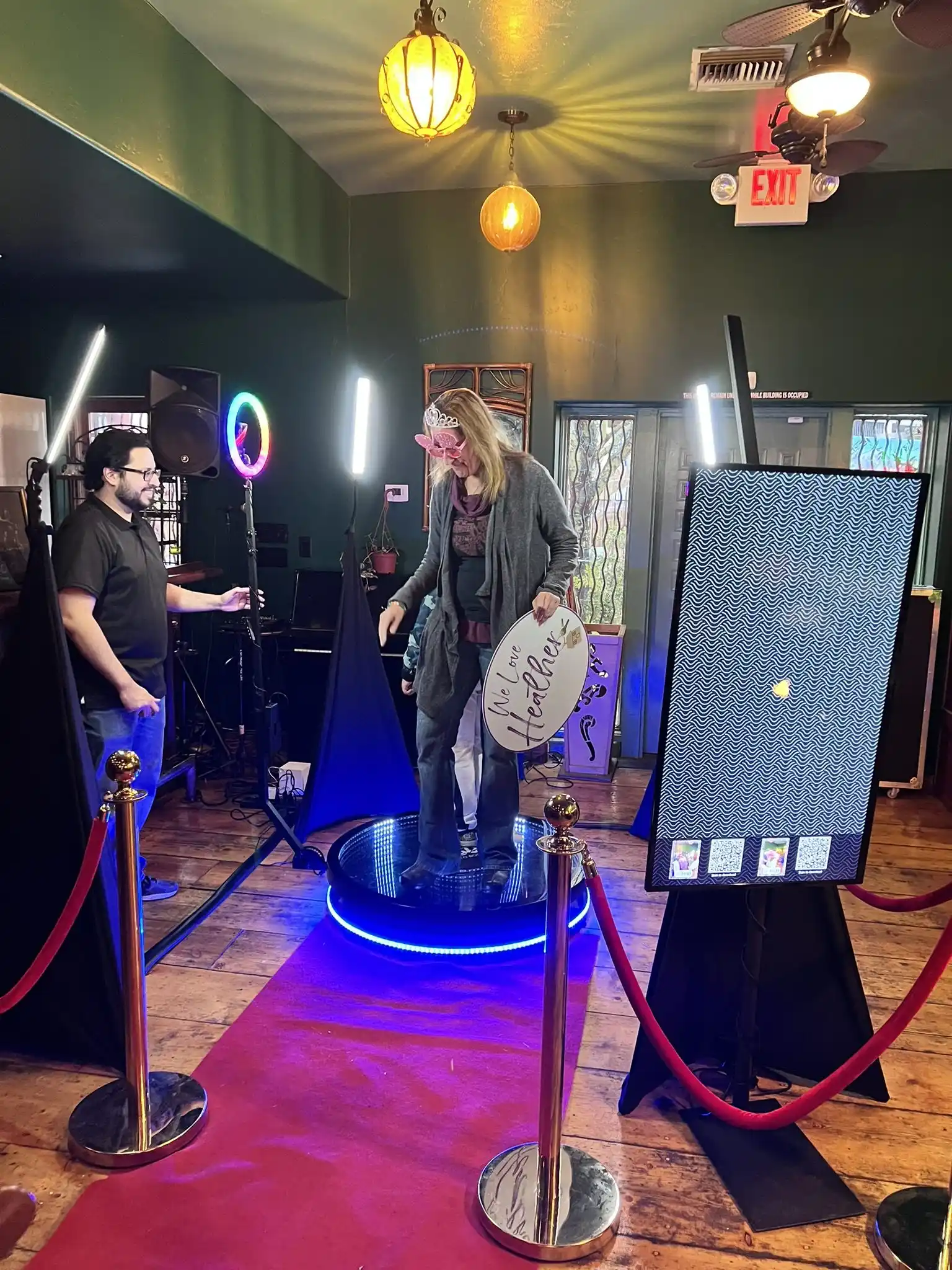 Guest on the 360 platform under blue event lighting
