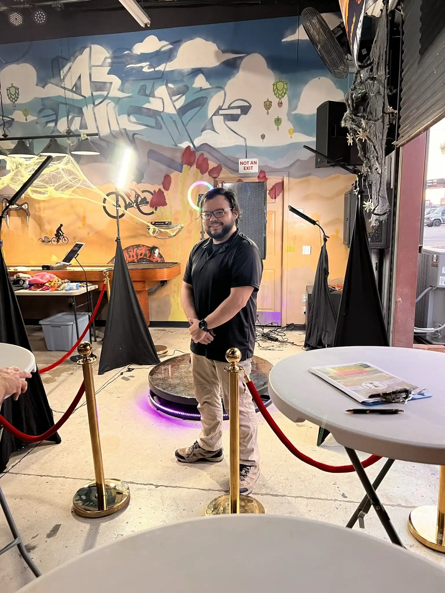 360 video booth set up in front of a mural
